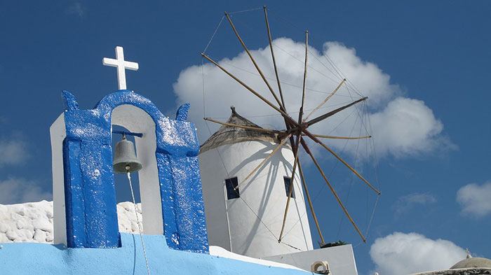 The scattered windmills in Oia