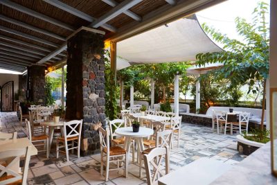 the wine area in an old cellar, a beautiful outdoor patio, and a wine retail shop